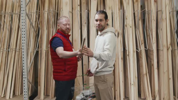 Male Hardware Store Worker Helping Customer