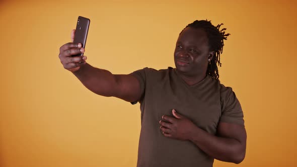 Young African American Black Man Using Smartphone To Take Selfie.