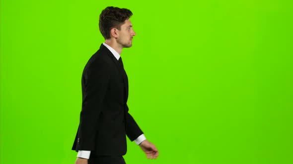 Man Goes To Work, with a Diplomat He Waves His Hand To Others. Green Screen