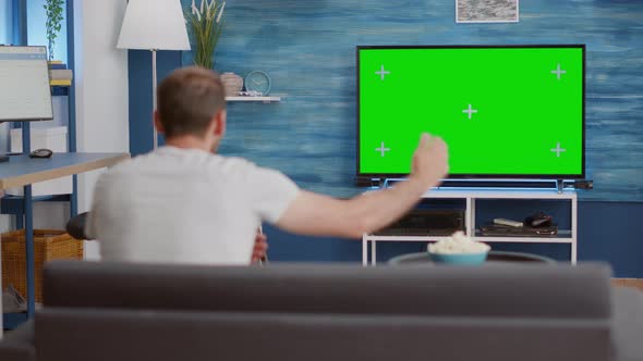 Sports Fan Watching Game on Green Screen Tv Mockup Encouraging Favourite Team While Relaxing at Home