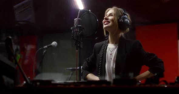Beautiful Woman Sings a Love Song in Recording Studio