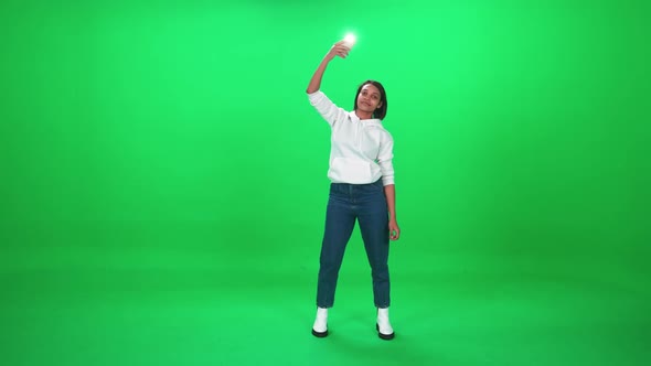 African Woman Dancing at a Music Concert Woman Holding Smartphone with Flashlight and Swing Their