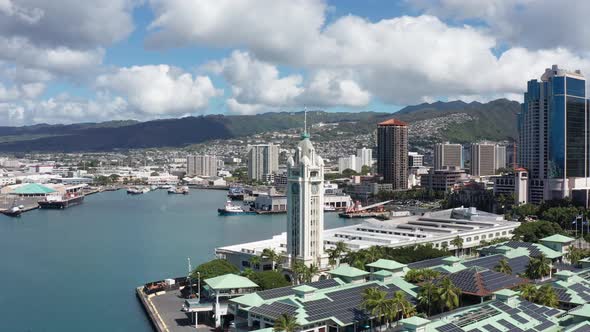 Aerial push-in close-up shot of the Aloha Tower in the Port of Honolulu on the island of O'ahu, Hawa