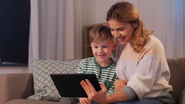 Mother and Son with Tablet Pc Having Video Call