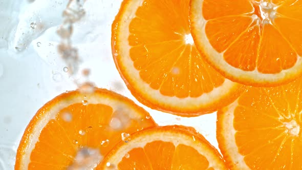 Super Slow Motion Shot of Splashing Orange Slices at 1000Fps