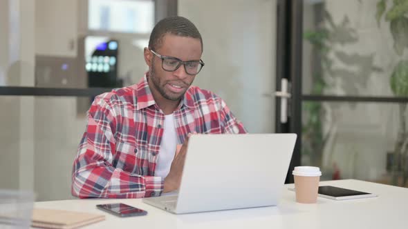 African Man Talking on Video Chat on Laptop