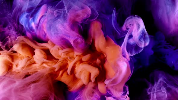 Blue Orange Colors Paint Slow Motion Ink Flow with Splash Isolated on Black