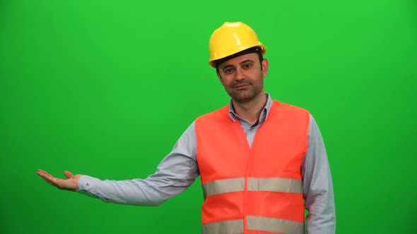 Engineer Worker Lifting Or Presenting Something on Green Screen