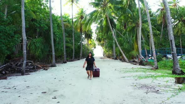 Single lady sunbathing on paradise bay beach break by blue sea with white sand background of the Mal