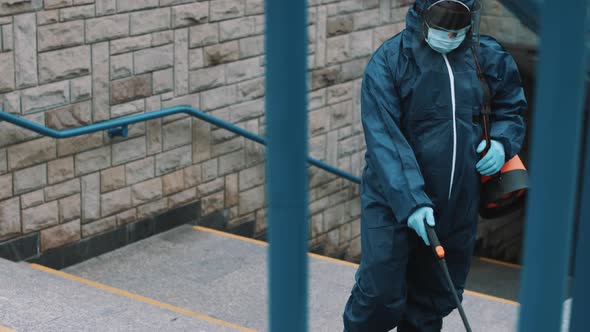 African Man with Protective Suit Disinfecting the Streets
