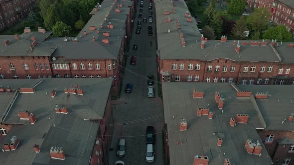 Redbrick Apartments And The Church Of Saint Anne In Nikiszowiec, Katowice, Poland. aerial, forward