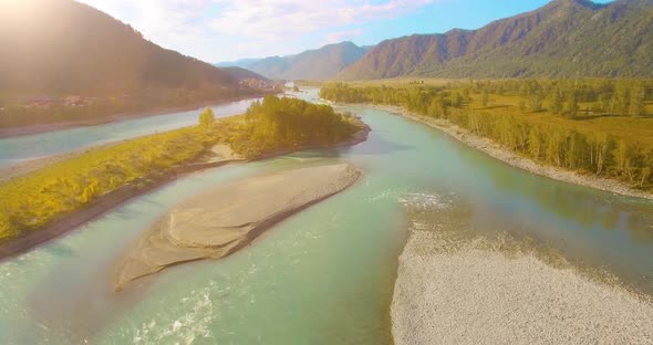 Low Altitude Flight Over Fresh Fast Mountain River with Rocks at Sunny Summer Morning