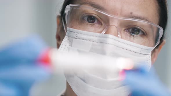 Doctor in Face Mask Holding Test Tube with Blood Sample