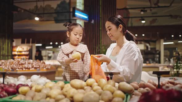 Mother and Daughter Go Shopping to Vegetable Store Together