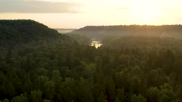 Amazing sunset over European forest and river, beautiful aerial landscape