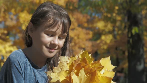 Portrait of a Child with Yellow Leaves