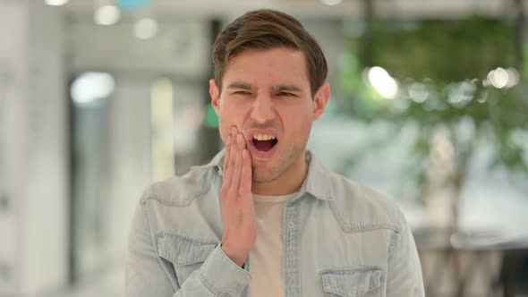 Portrait of Creative Young Man Having Toothache Cavity