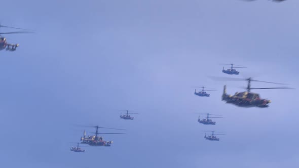 a large number of helicopters flying against the blue sky