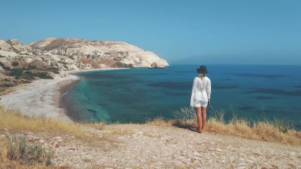 Woman Traveler Looks at Rock Aphrodite View From Back