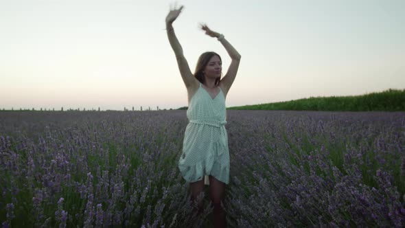 Woman Dances on the Lavender Field in the Evening
