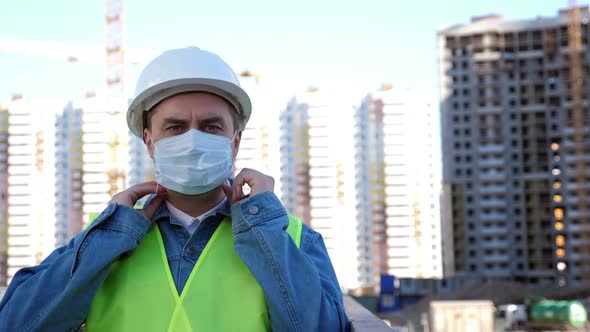 Worker Staff in White Helmet Put on and Put Off Medical Mask at Construction Site