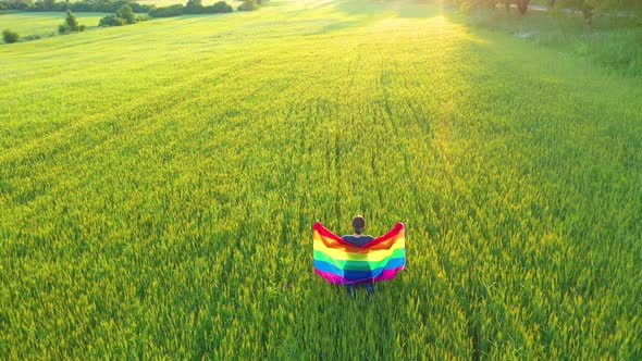 Flying Over Lesbian Gay Woman Holding Rainbow Flag in the Outdoors