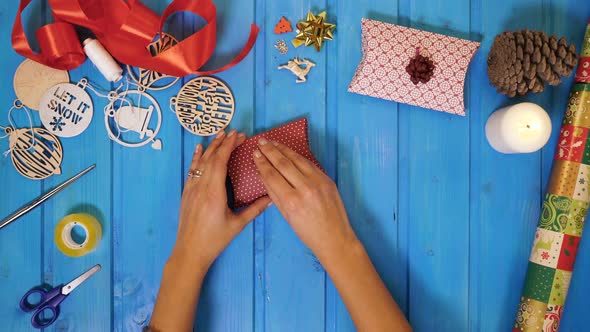 Hands putting a bow on a gift box