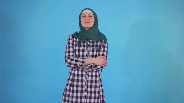 Young Muslim Woman Finds New Idea on Blue Background