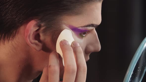 Drag Artist  Young Man Cleaning Out His Under Eyes with Applying White Powder Using a Sponge