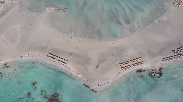 Aerial bird view of a paradise beach with umbrellas. Idyllic vacation concept