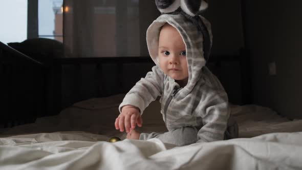 Cute Toddler Boy with Bunny Ears Crawling on Bed Easter Concept