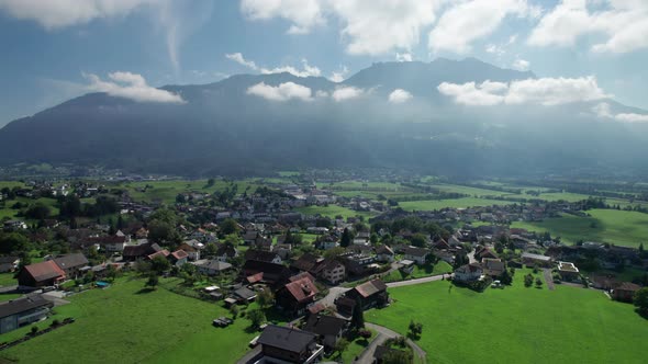 Aerial View of Liechtenstein with Houses on Green Fields in Alps Mountain Valley