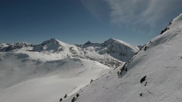 Skiing with a beautiful aerial view of the mountain  cover with snow on a sunny day