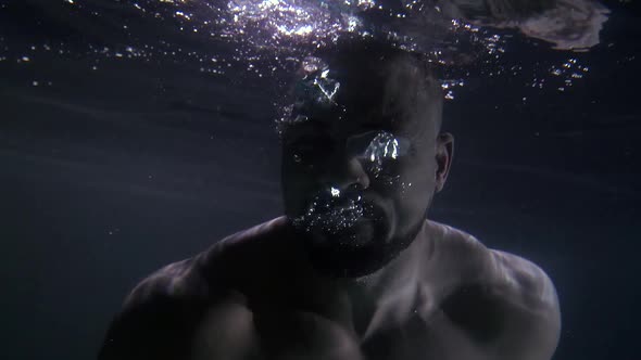 A Sporty African Under Water with a Naked Torso Screams and Shows Emotions of Pain