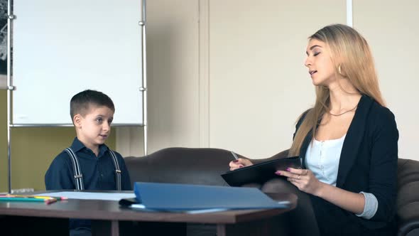 Professional Psychologist Talking to a Schoolboy