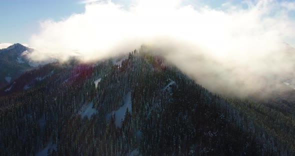 Gorgeous Beautiful Lighting Above Mountain Peak Evaporating Clouds Helicopter Aerial Perspective