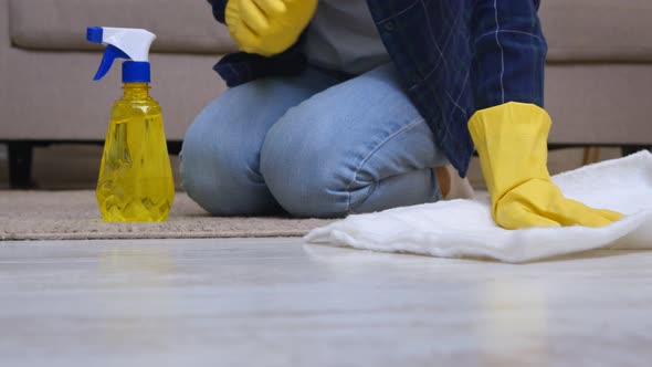 Woman in Rubber Gloves Spraying Cleanser on Floor and Washing It Close Up Slow Motion Shot