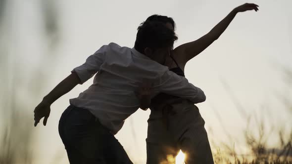 Slow motion shot of couple dancing outdoors in the evening