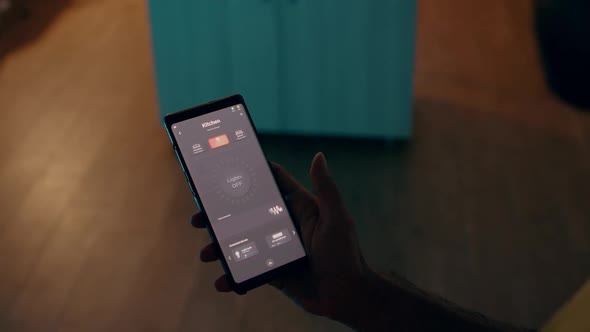Close Up of Man Using Voice Activated Application to Turn on Bulbs