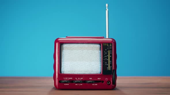 Small Old Television with Grey Interference Screen on Blue Background