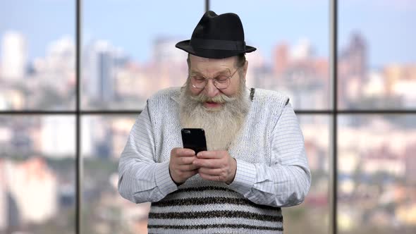 Funny Senior Man Using Cell Phone