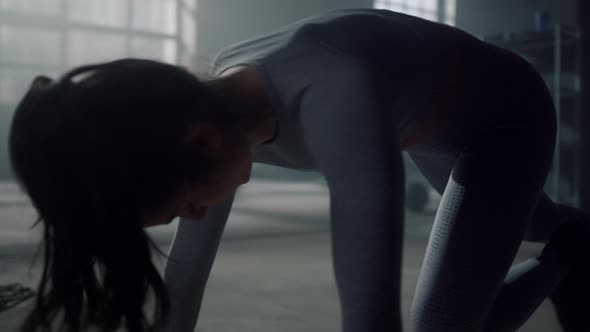 Woman Doing Push Ups on Floor in Gym