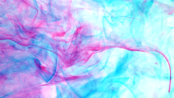 An abstract background of slow moving blue and pink dye ink under the water