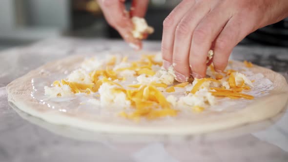 Chef Spreading Sour Cream and Cheese Over Pizza Dough Cooking Italian Pizza
