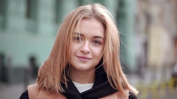 Closeup Portrait of Attractive Young Female 20s Standing in Front of Building Having Positive