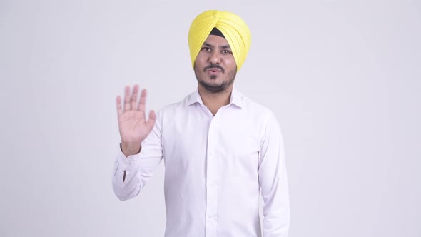 Happy Bearded Indian Sikh Businessman Waving Hand