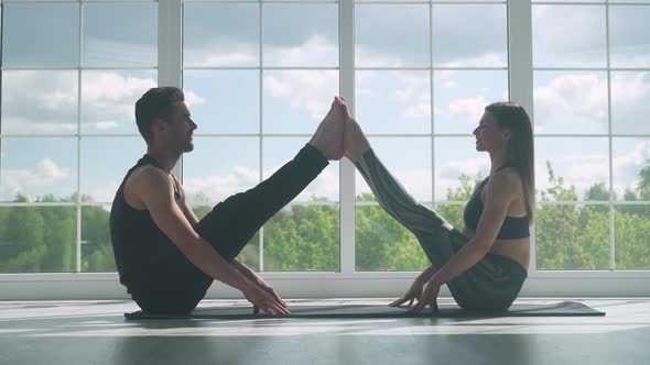 Wellness, Man and a Woman Do Yoga Together, Perform Stands and Muscle Stretching, Joint Training