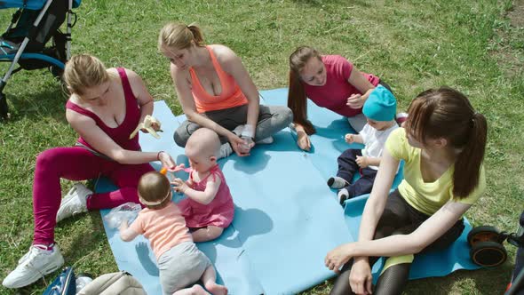 Mother Having Picnic in the Park with Babies alt