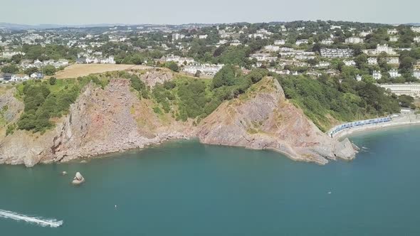 Aerial Paralax effect of Cliffside, revealing water and boater.