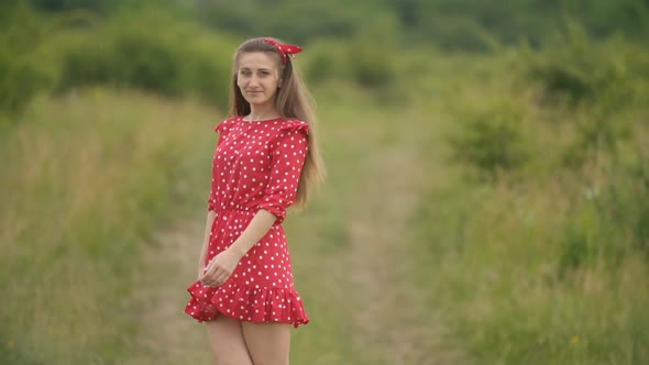 Girl Walking on a Dirt Road